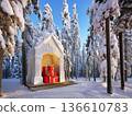 Snowy winter scene with decorative gift boxes in forest setting 136610783
