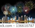 Colorful fireworks display over modern city skyline at night 136610787