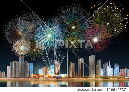 Colorful fireworks display over modern city skyline at night 136610787
