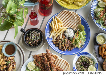 many different mediterranean food dishes on restaurant table in greece 136610953