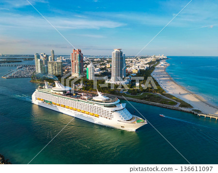 Aerial view of cruise in summer vacation. Cruise ship tour and travel at sea. Aerial view of luxury liner voyage. Ship leaving Miami beach port. Miami tour. Cruise ship voyage. Grand ocean voyage 136611097