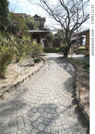 A Japanese-style garden with stone-paved paths and traditional architecture A Japanese-style garden with stone-paved paths and traditional architecture 136611233