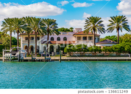 Waterfront landscape with house. Vacation in summer. Luxury waterfront hotel building. Summer vacation. Landscape with luxury residential area. Residential waterfront apartment. Palm tree Waterfront landscape with house. Vacation in summer. Luxury waterfront hotel building. Summer vacation. Landscape with luxury residential area. Residential waterfront apartment. Palm tree 136611249