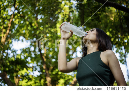 Young Woman Drinking Water bottle outdoor park traveler. Asian female drinking water bottle healthy person happy smile. Happiness Beautiful asian chinese women holding mineral water bottle lifestyle Young Woman Drinking Water bottle outdoor park traveler. Asian female drinking water bottle healthy person happy smile. Happiness Beautiful asian chinese women holding mineral water bottle lifestyle 136611450