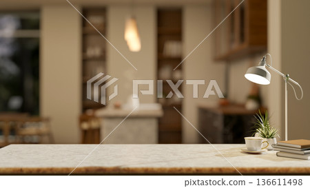 Coffee or tea cup aside books and pot plant under lamp on marble in a modern dining room or kitchen. 136611498