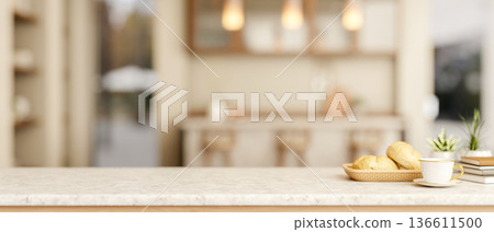 Coffee cup with breads on marble table across counter bar and cupboard in a kitchen or dining room. Coffee cup with breads on marble table across counter bar and cupboard in a kitchen or dining room. 136611500