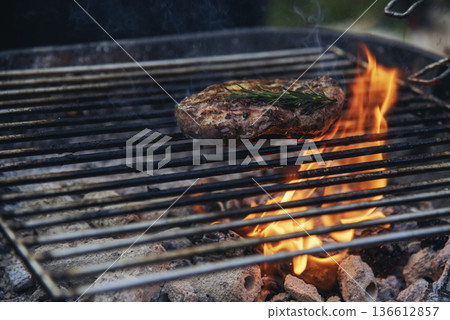 BBQ Barbecue grilled meat stick on fire flame with hot charcoal cooking outside. Beef grilling picnic outdoor with smoke bacon spicy sausage for party. Grill pork bbq on fire flame 136612857