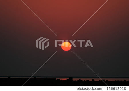 The gradation of the red sunset in Hamaatsuma, Hokkaido, on the Pacific Ocean 136612918