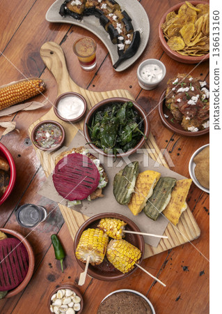 mixed colombian and venezuelan food meal spread on wooden restaurant table mixed colombian and venezuelan food meal spread on wooden restaurant table 136613160