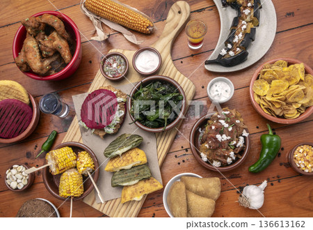 mixed colombian and venezuelan food meal spread on wooden restaurant table mixed colombian and venezuelan food meal spread on wooden restaurant table 136613162