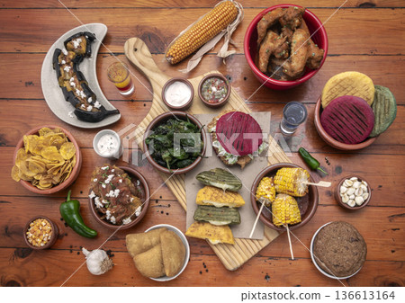mixed colombian and venezuelan food meal spread on wooden restaurant table 136613164