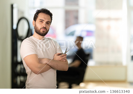 Barbershop owner with scissors portrait in hair salon Barbershop owner with scissors portrait in hair salon 136613340