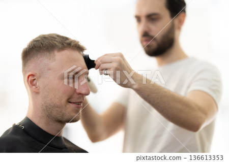 Client receiving a fresh haircut for modern look 136613353