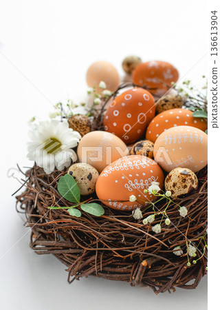 Easter nest with hand-painted eggs on a light background Easter nest with hand-painted eggs on a light background 136613904