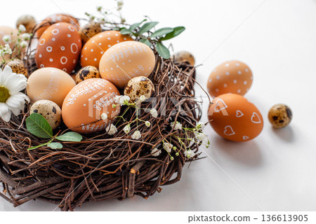 Easter nest with hand-painted eggs on a light background Easter nest with hand-painted eggs on a light background 136613905