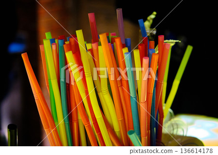 Colorful Plastic Drinking Straws in Bar Setting 136614178