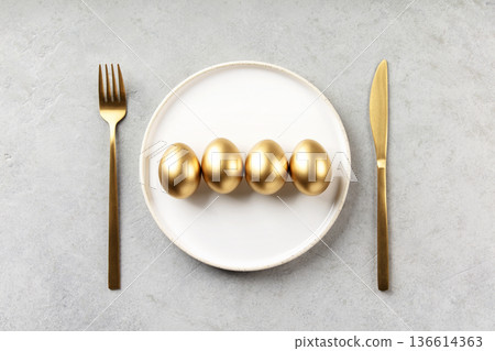 Golden Eggs on White Plate with Luxury Table Setting Golden Eggs on White Plate with Luxury Table Setting 136614363