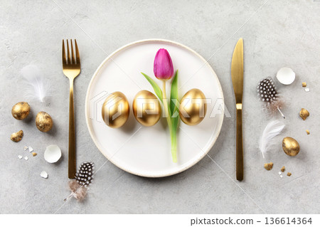 Elegant Easter Table Setting with Golden Eggs and Tulip 136614364