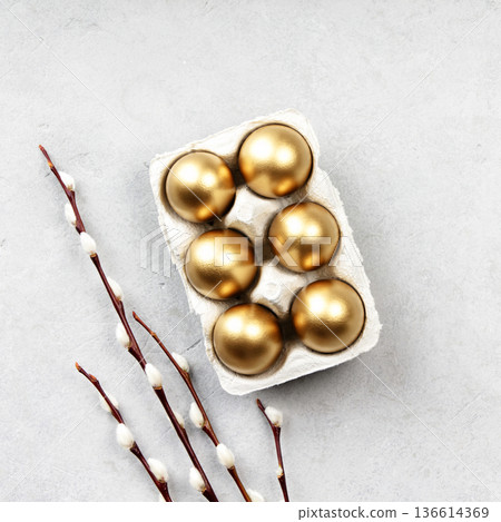 Golden Easter Eggs with Willow Branches on Light Background 136614369