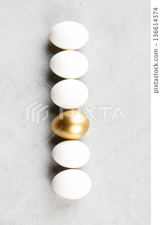 Minimal Easter Concept with Golden Egg Among White Eggs Minimal Easter Concept with Golden Egg Among White Eggs 136614374