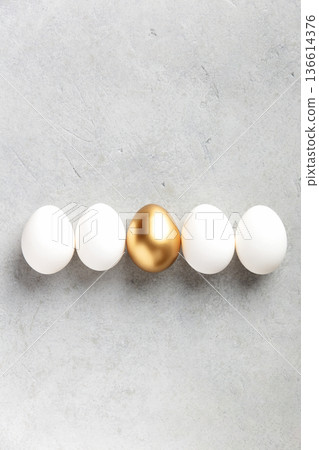 Minimal Easter Concept with Golden Egg Among White Eggs Minimal Easter Concept with Golden Egg Among White Eggs 136614376