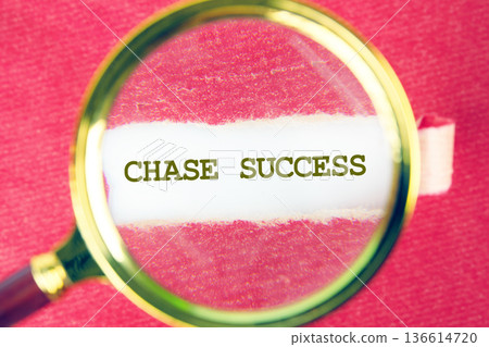 A magnifying glass brings clarity to the powerful words encouraging individuals to chase their dreams and find success, set against a vibrant background A magnifying glass brings clarity to the powerful words encouraging individuals to chase their dreams and find success, set against a vibrant background 136614720