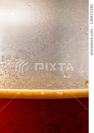 Water droplets forming on the glass of iced coffee 136615280