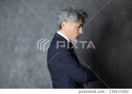 Profile of a businessman in a suit thinking Profile of a businessman in a suit thinking 136615892