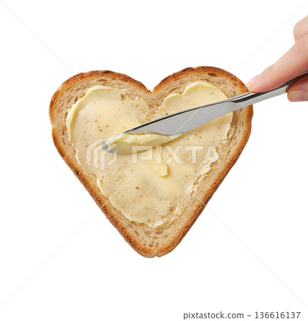 Hands spreading creamy butter on a golden brown heart-shaped toast, perfect for breakfast, valentine's day, and romantic morning concepts Hands spreading creamy butter on a golden brown heart-shaped toast, perfect for breakfast, valentine's day, and romantic morning concepts 136616137