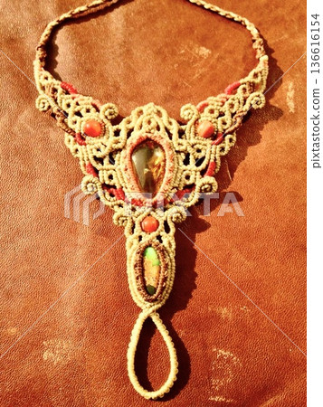 Gold necklace and colorful necklaces on a black background 136616154