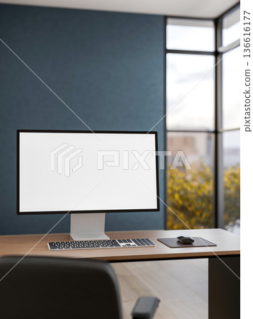 White screen computer on wooden table with a leather chair in dark blue office and glass wall window 136616177