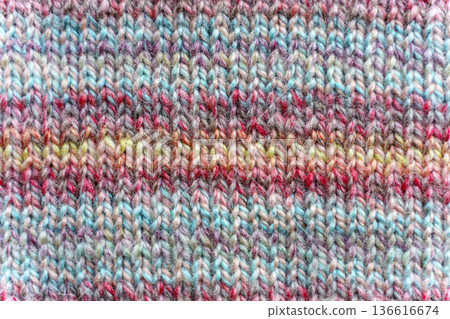 Close-up Texture of Handmade Knitted Clothing with Colorful Yarn Patterns Close-up Texture of Handmade Knitted Clothing with Colorful Yarn Patterns 136616674