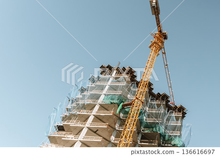 Construction of a building. Construction site with crane. Business, development, industry. Construction of a building. Construction site with crane. Business, development, industry. 136616697