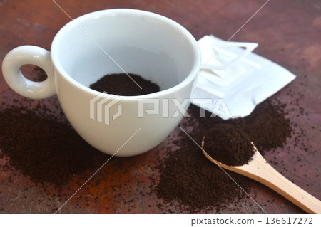coffee drip powder with filter and wooden spoon in mug glass on table coffee drip powder with filter and wooden spoon in mug glass on table 136617272