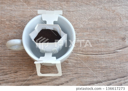 coffee drip powder with filter and wooden spoon in mug glass on table coffee drip powder with filter and wooden spoon in mug glass on table 136617273
