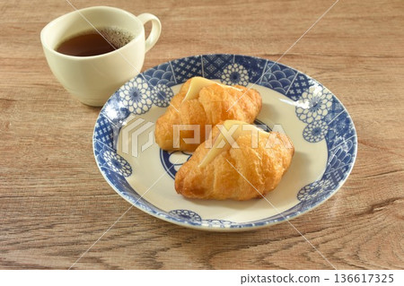 baking crispy butter croissant French bread stuffed ham cheese on plate eat with black hot coffee cup baking crispy butter croissant French bread stuffed ham cheese on plate eat with black hot coffee cup 136617325