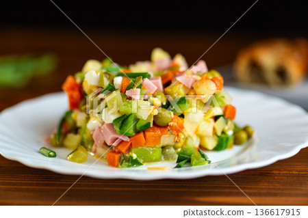 Traditional Olivier salad with vegetables and creamy dressing 136617915