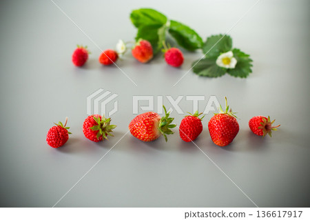 Appetizing red strawberries in a minimalistic composition Appetizing red strawberries in a minimalistic composition 136617917