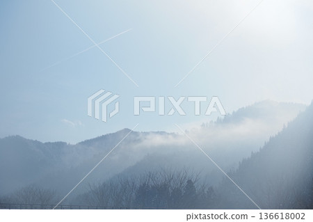 mountains, blue sky and contrails 136618002