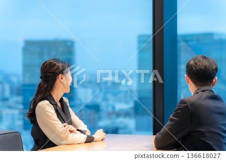 A couple watching the night view from the lounge A couple watching the night view from the lounge 136618027