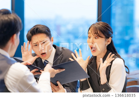 A couple is surprised when they look at the menu at the counter A couple is surprised when they look at the menu at the counter 136618035