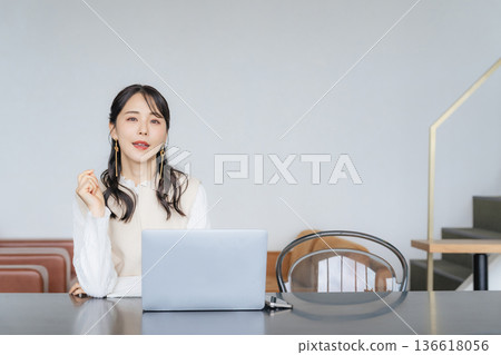 Woman working on a laptop in the office 136618056