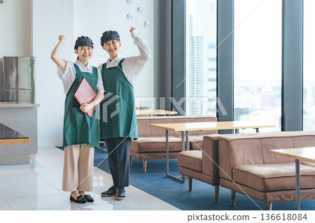 A restaurant employee pumping his fist in the store A restaurant employee pumping his fist in the store 136618084