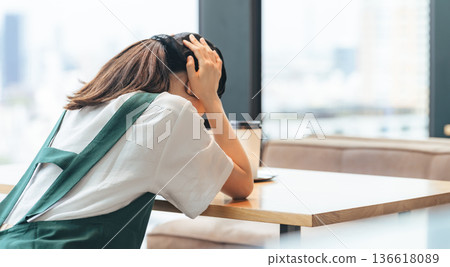 A restaurant employee worried inside the store A restaurant employee worried inside the store 136618089