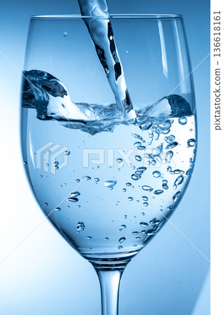 pour water into a cup 136618161