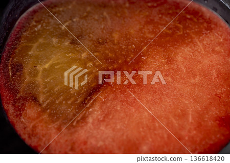 sliced black fresh juicy plums on the kitchen table, some beautiful pure black plums on the table, plum with red sweet flesh cut into pieces sliced black fresh juicy plums on the kitchen table, some beautiful pure black plums on the table, plum with red sweet flesh cut into pieces 136618420