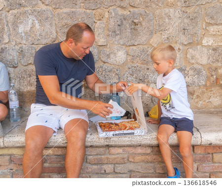 Father spending time with young child in historic town environment. Image suitable for family oriented content, social lifestyle themes, travel documentation Father spending time with young child in historic town environment. Image suitable for family oriented content, social lifestyle themes, travel documentation 136618546