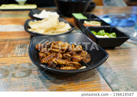 Traditional Korean Street Food Beondegi Boiled Silkworm Pupae in a Black Bowl Traditional Korean Street Food Beondegi Boiled Silkworm Pupae in a Black Bowl 136618587