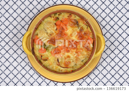 Baked vegetable gratin with melted cheese in a ceramic pot Baked vegetable gratin with melted cheese in a ceramic pot 136619173
