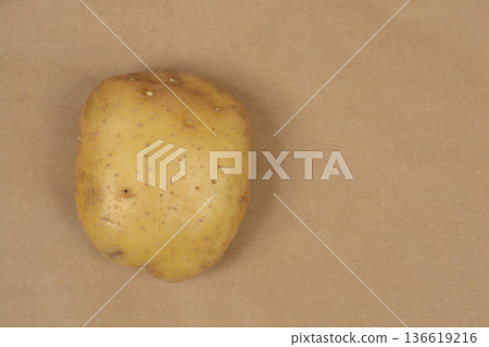 Raw Potato on Brown Background Raw Potato on Brown Background 136619216